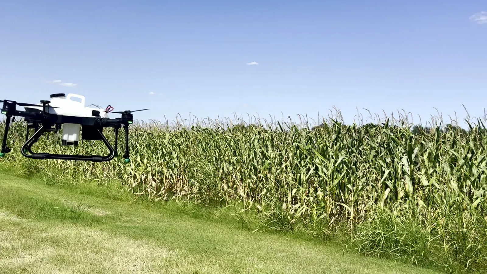 American Prime spray drone in flight low over a corn field during field validation