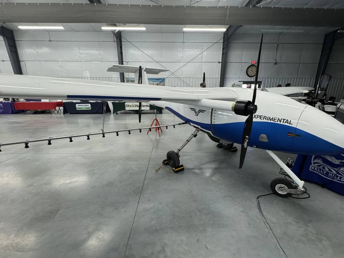 Experimental fixed-wing agricultural spray aircraft in a hangar