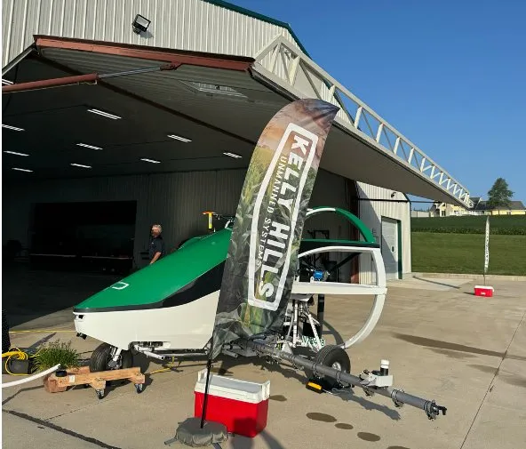 Agricultural spray aircraft on display at a field-day hangar