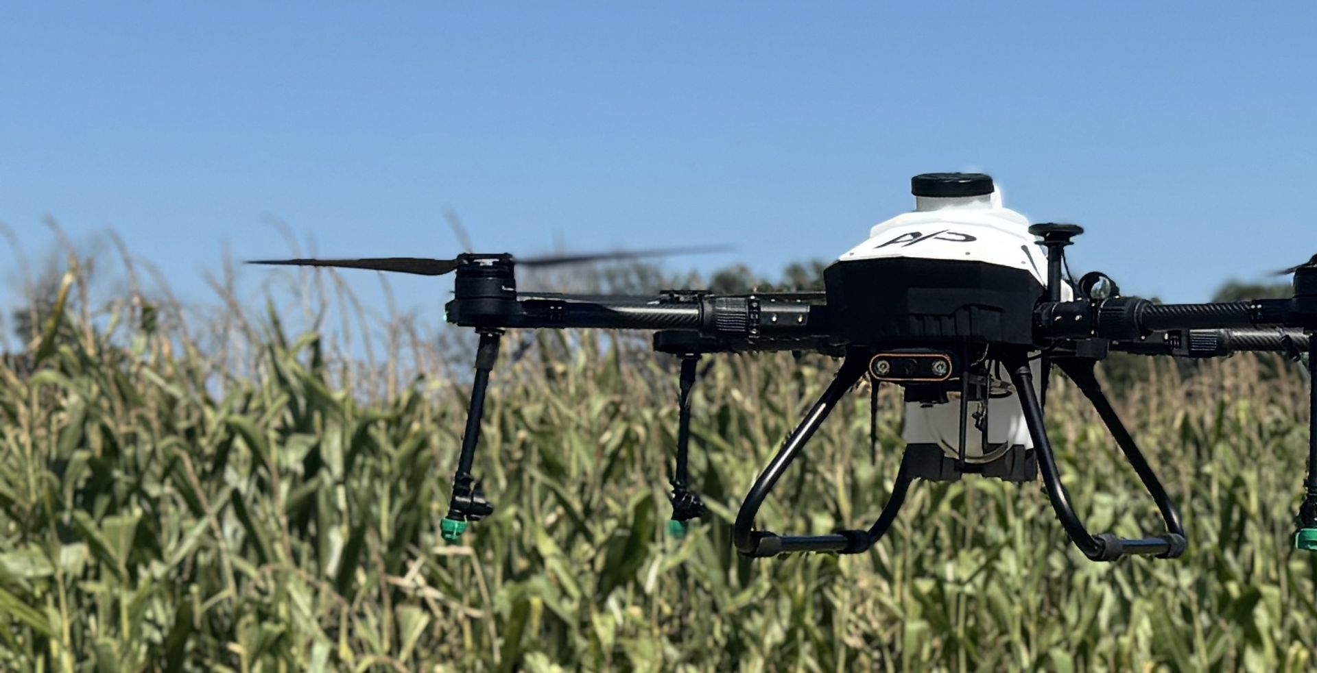 American Prime agricultural spray drone flying low over a corn field
